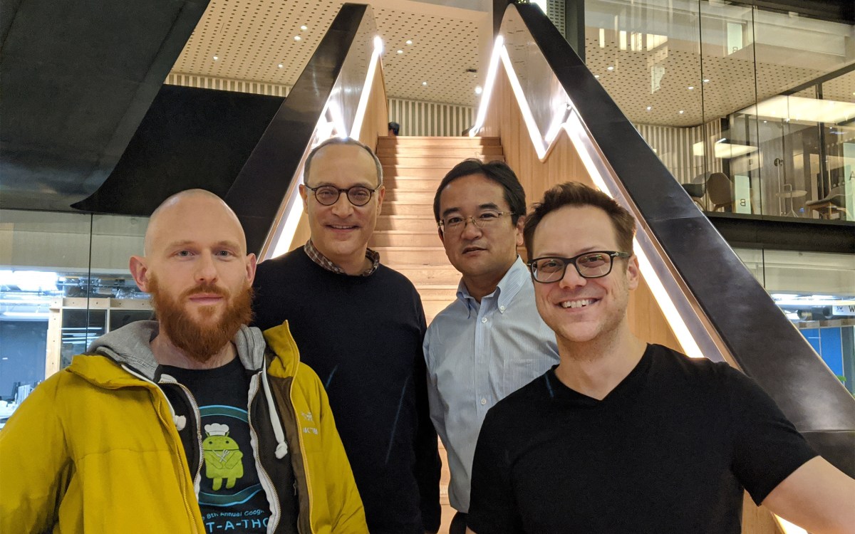 Researchers standing on stairwell.