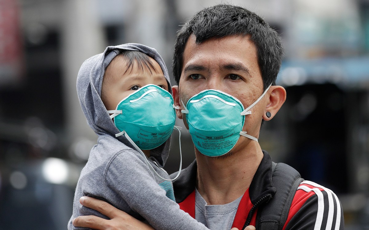 Adult and child wearing flu masks.