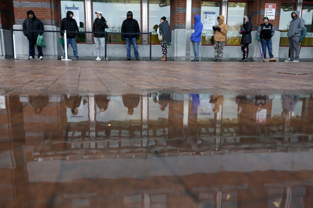 People standing in line but keeping their distance.