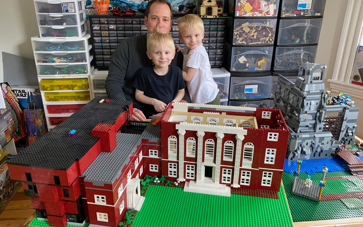 Jonathan Savilonis and sons Julius and Lysander with their LEGO model of Harvard's Music Building.