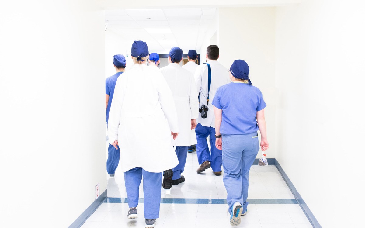 Doctors and nurses walking down a corridor.