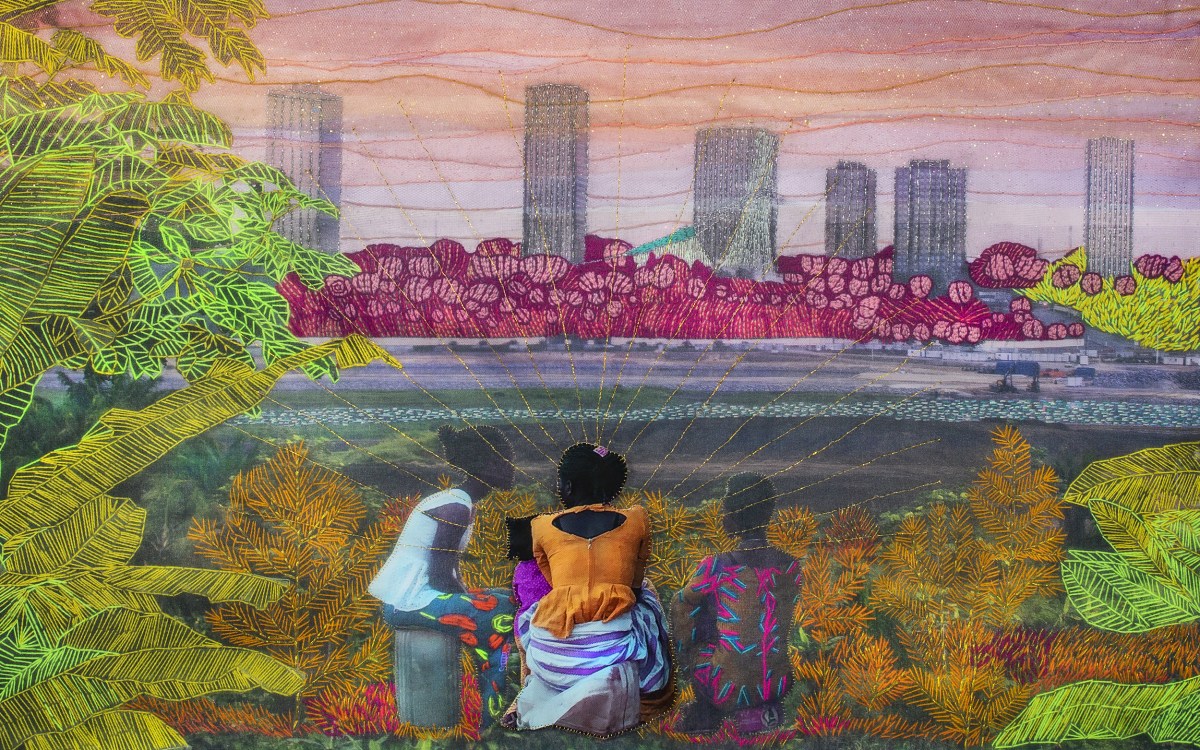 Embroidered photo of three people looking at cityscape and sunset across body of water.