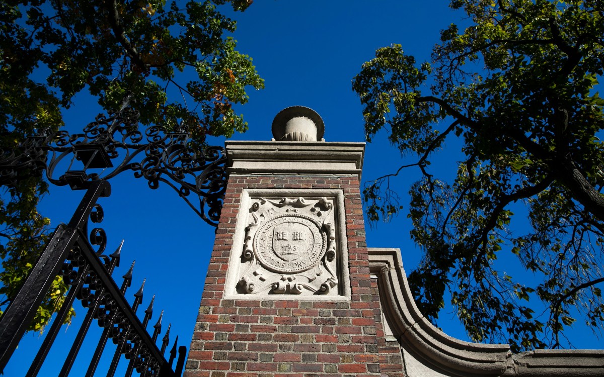 A veritas shield decorates a gate that encircles Harvard Yard.