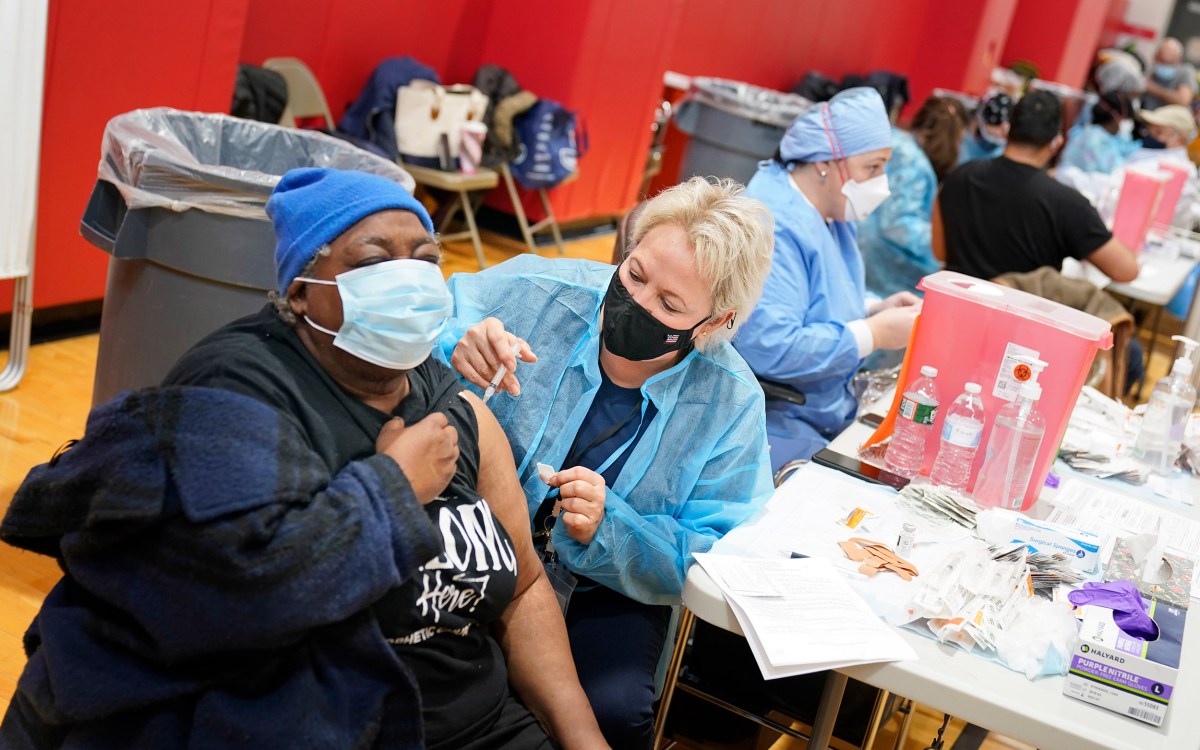 Woman getting vaccine at clinic.