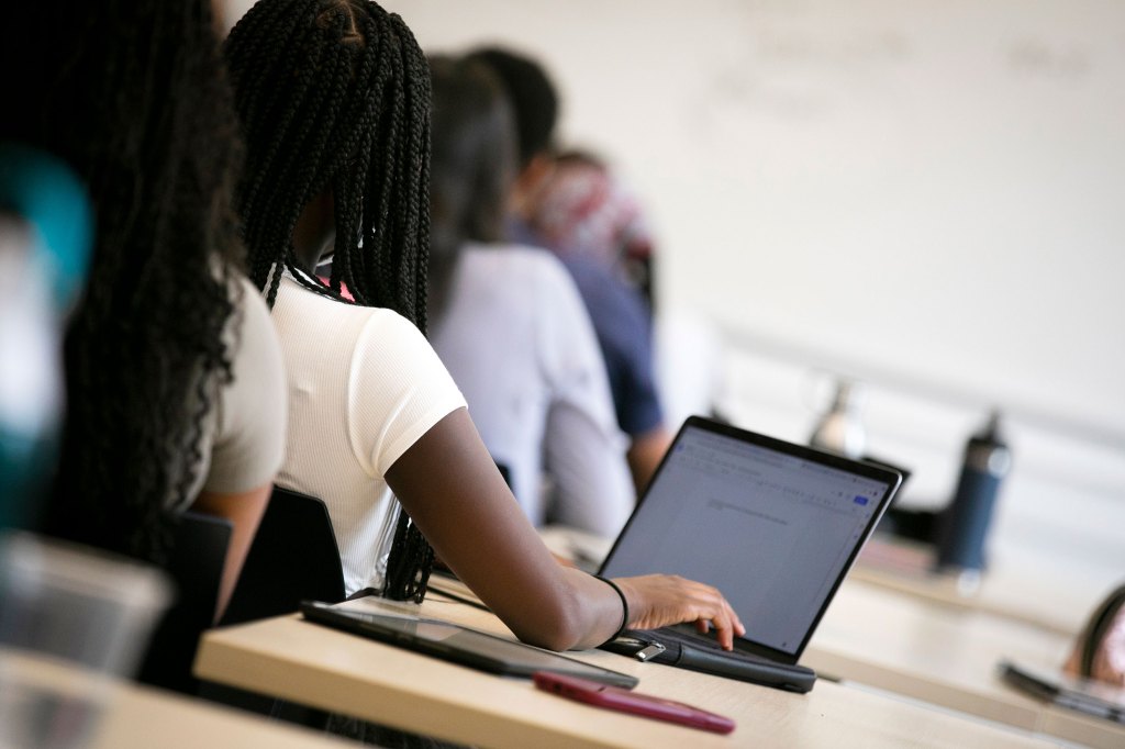 Students with computers in class.