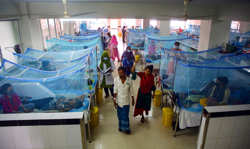 Patients lie under mosquito nets in Dengue ward in Bangladesh.