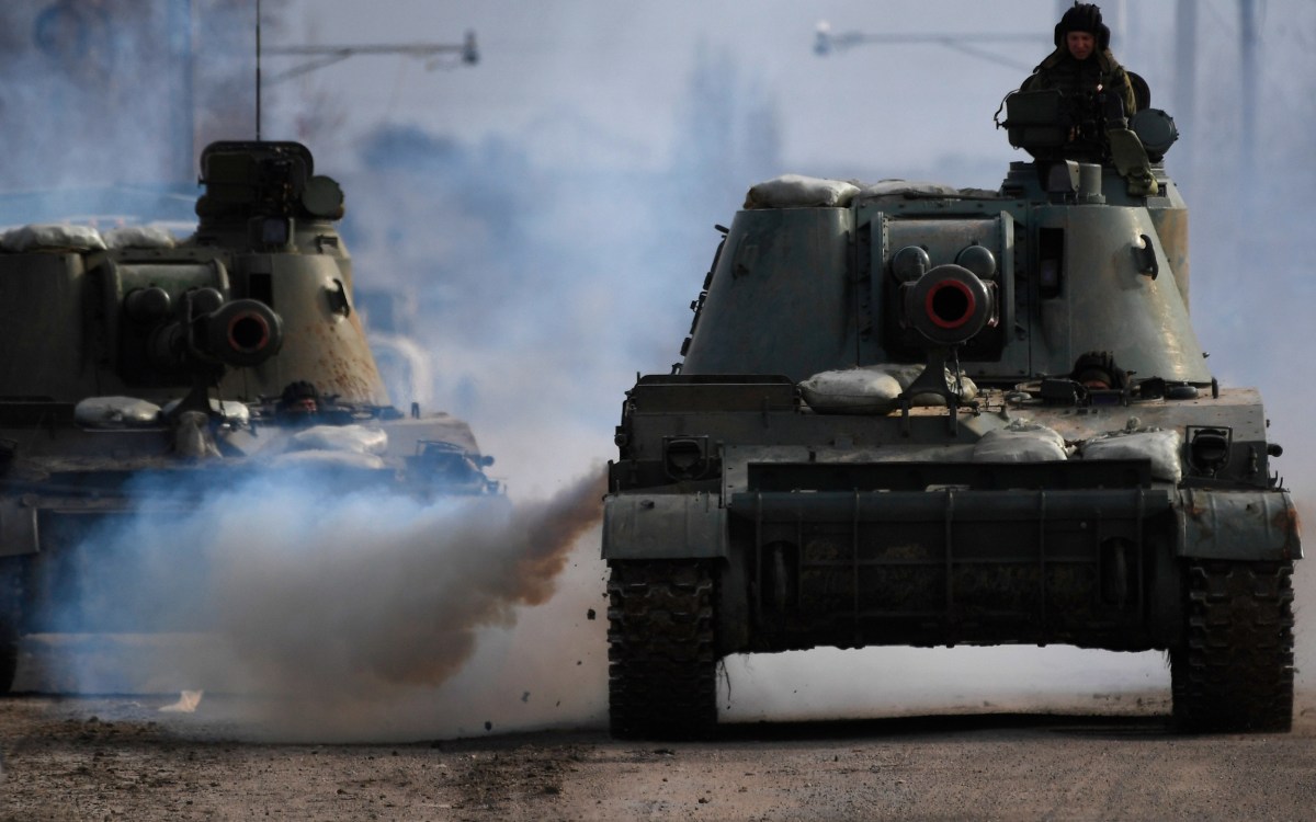 Armoured vehicles drive along a road in Armyansk