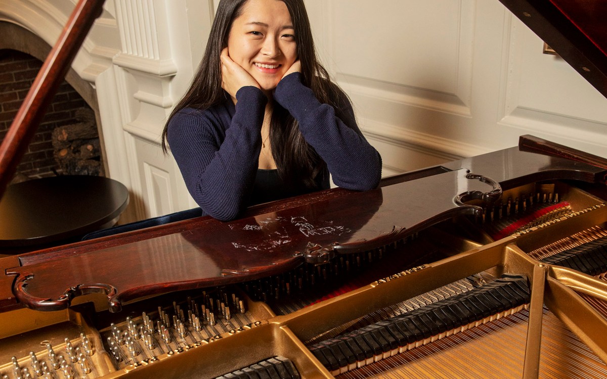 Julia Riew sits at piano.