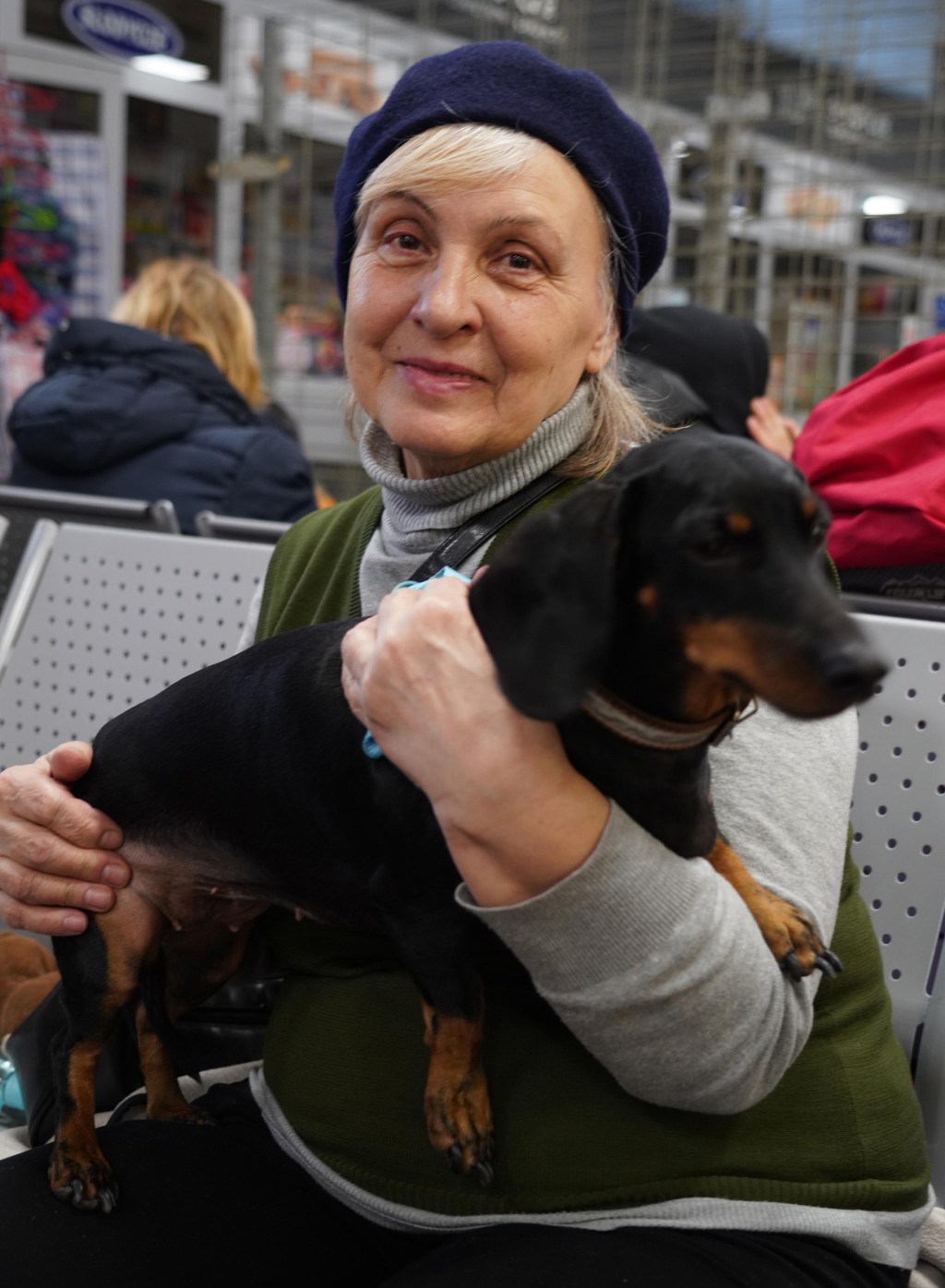 Ukrainian refugee holds family dog.