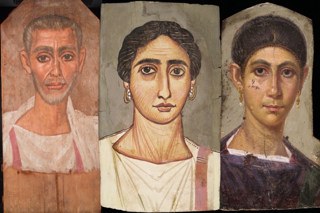 Three mummy portraits of bearded man wearing white tunic, woman wearing white tunic with purple sash, and woman wearing a purple tunic.