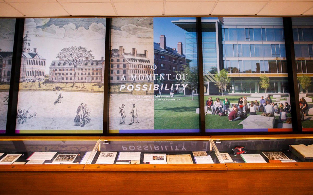 Main wall and glass case of an exhibition of historical items related to Harvard's presidency.