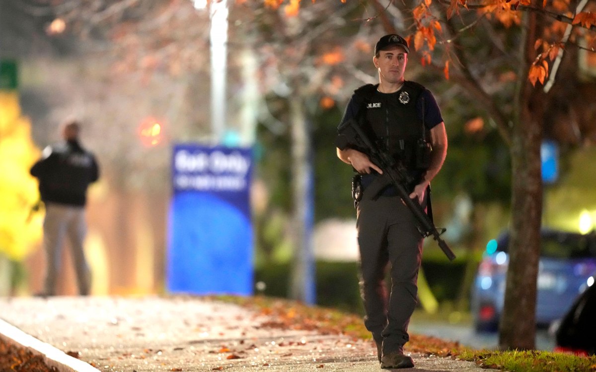 Law enforcement officers carry rifles outside Central Maine Medical Center.