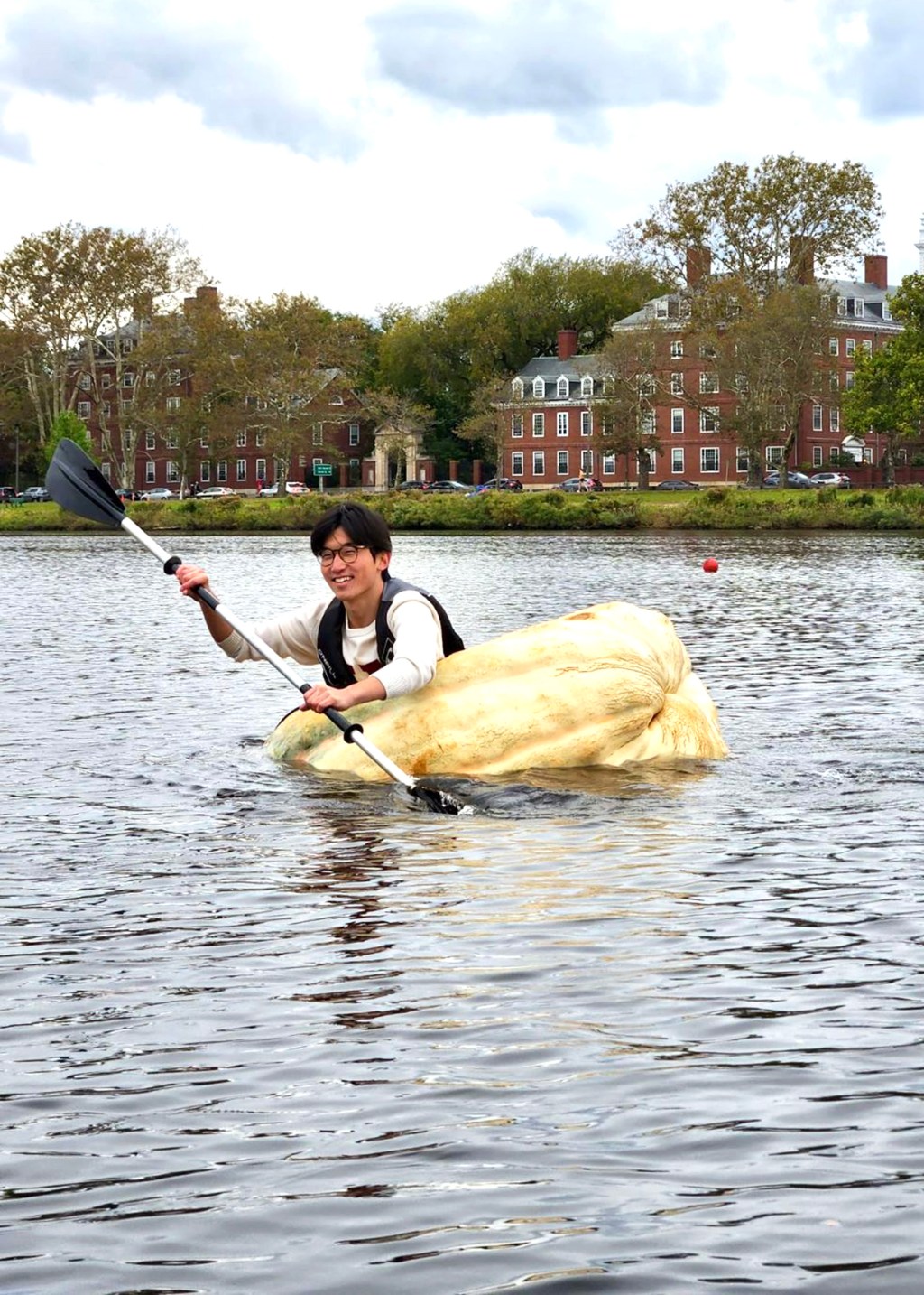 Benjamin Chang rows giant pumpkin across Charles River.