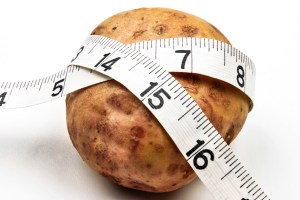 Potato wrapped in measuring tape.