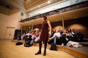 Professor Stephanie Burt standing in front of a classroom full of students.