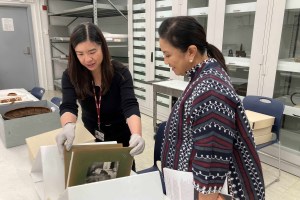 Archivist Marie Wasnock (left) sharing a photo album with former Philippines Vice President Leni Robredo.