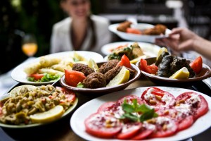 Woman being served food from the Mediterranean diet.