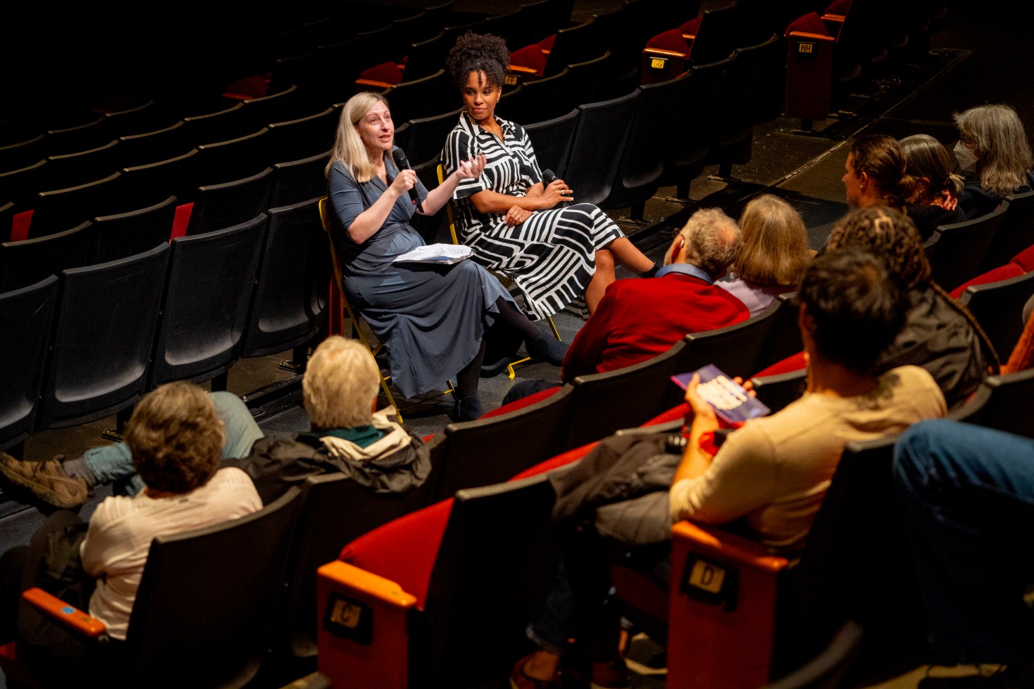 Meredith Goldstein (left) and producer Christine Ahanotu speaking inside the Loeb Drama Center.