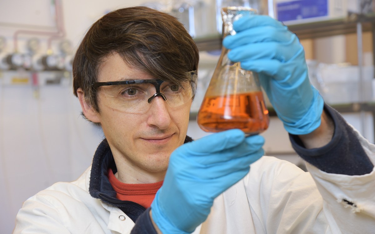 Felix Elling holds a flask containing an iron-oxidizing bacterium in his lab.