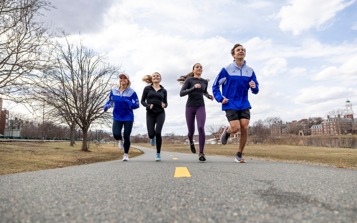 Bridget Kondrat, Maggie Chiappetta-Uberti, Brooke Stanford, and Andrew Athanasian run along the Charles River.