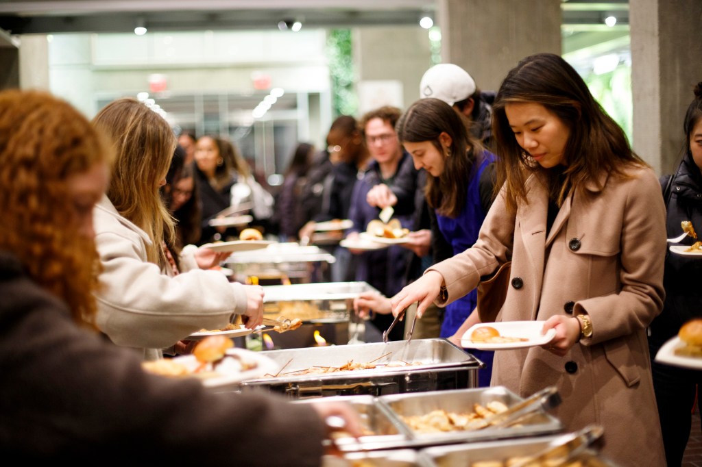 Students gather in the lobby of the Smith Campus Center to share food.