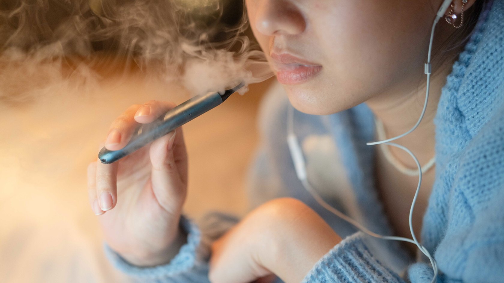 Young woman vaping.