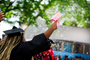 Tiffany Onyeiwu (pictured) blows bubbles during the ceremony.