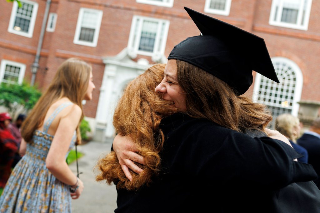 Linda Erickson (center) embraces her daughter Sarah Erickson