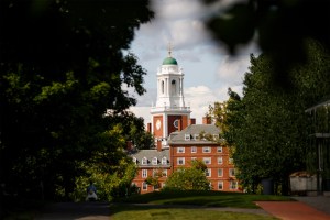 The Eliot House tower is framed by trees.