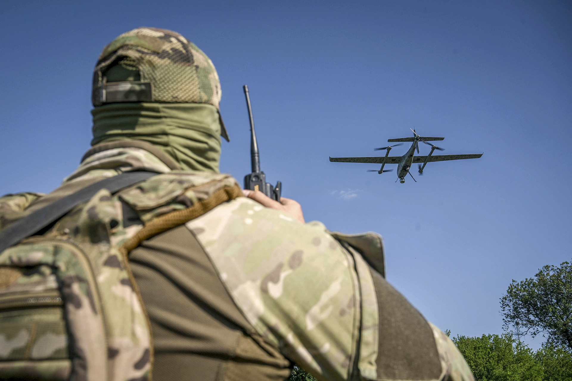 A serviceman launches a drone in Ukraine.