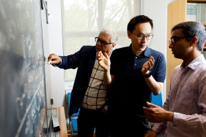 John Wang (center) discusses part of his coronavirus research with Eugene Shakhnovich (left), and doctoral student Vaibhav Mohanty (right)