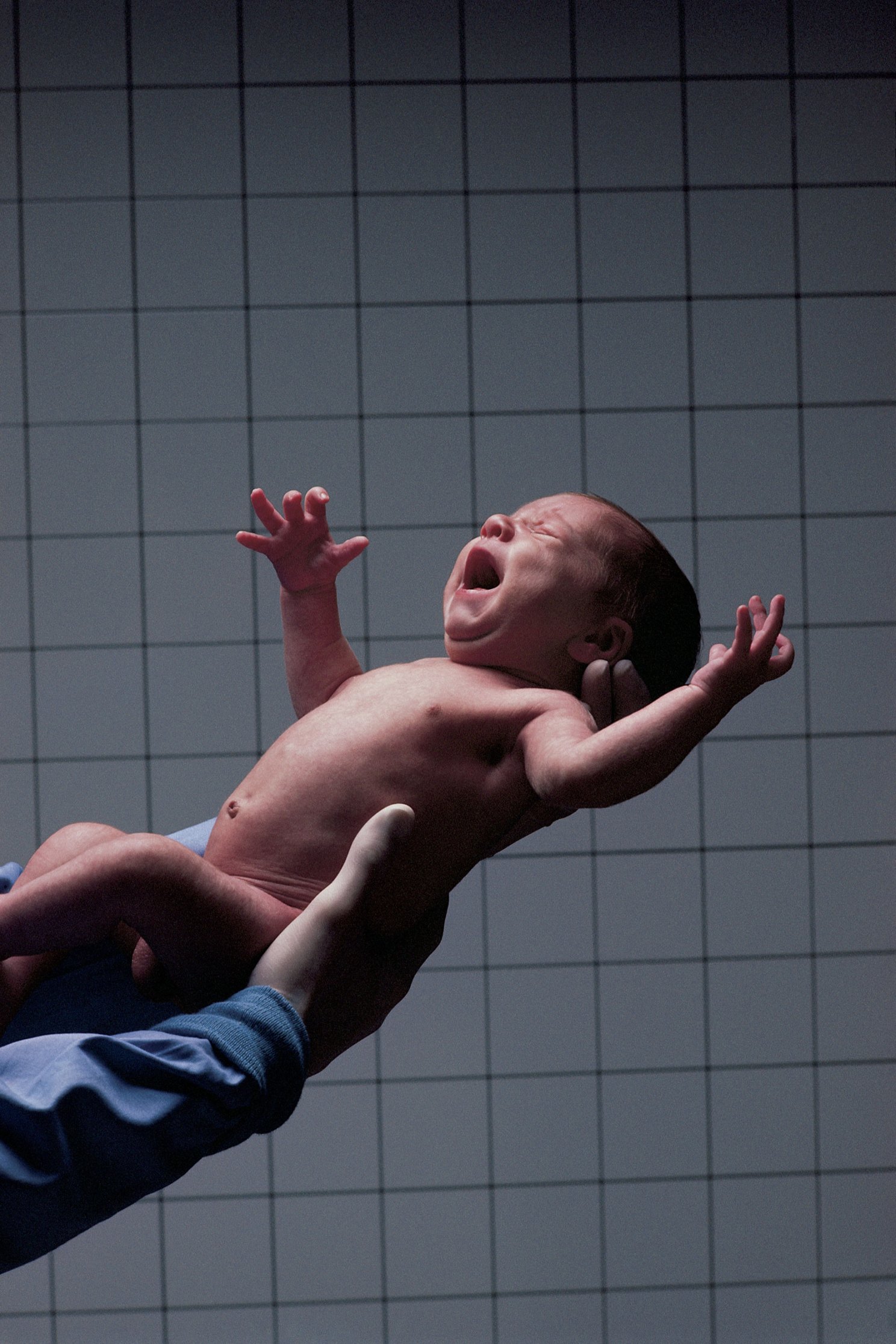 Doctor holding newborn.
