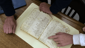 Gabriel Raeburn reviews documents with fellow American Ancestors researcher Christine Bachman-Sanders.