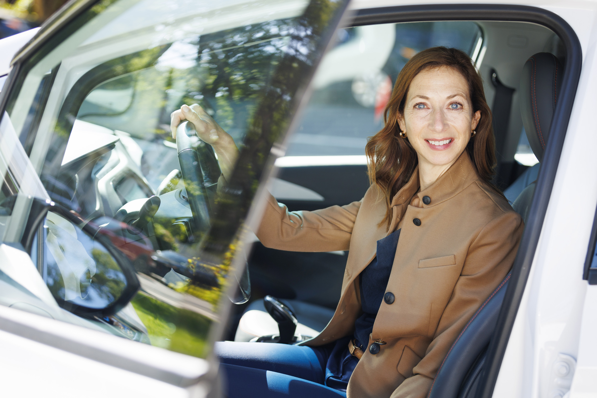 Elaine Buckberg in her EV.