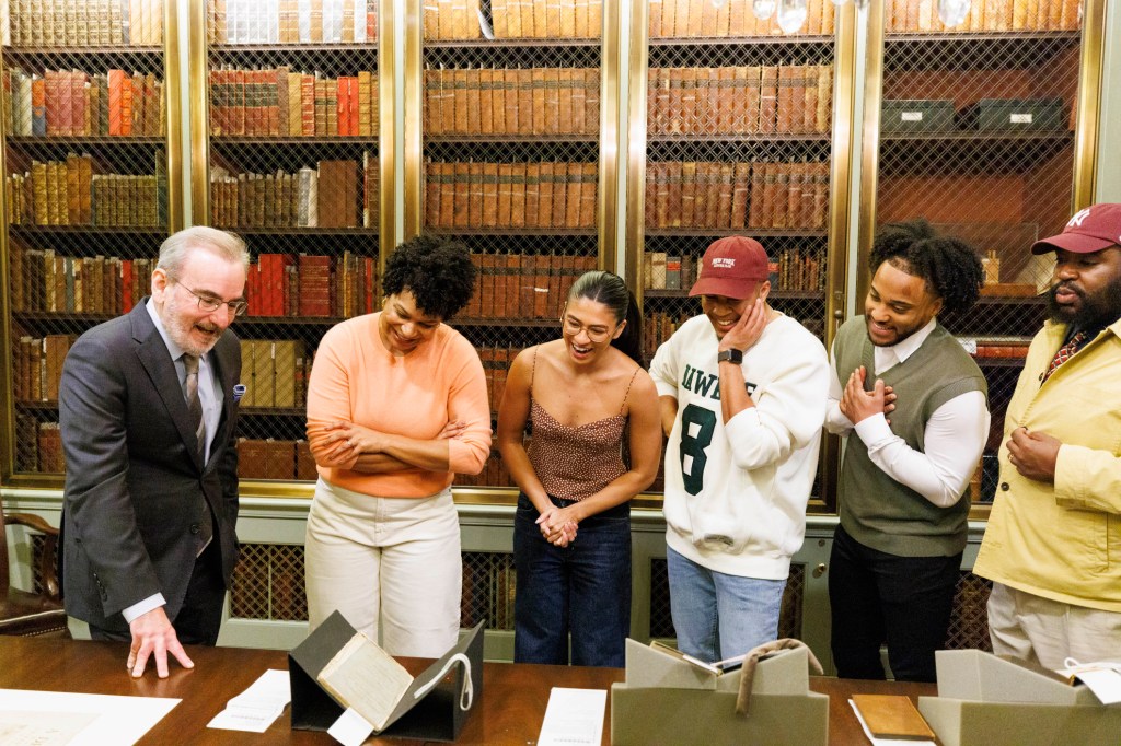 John Overholt showing documents to the cast of 'Hamilton'.