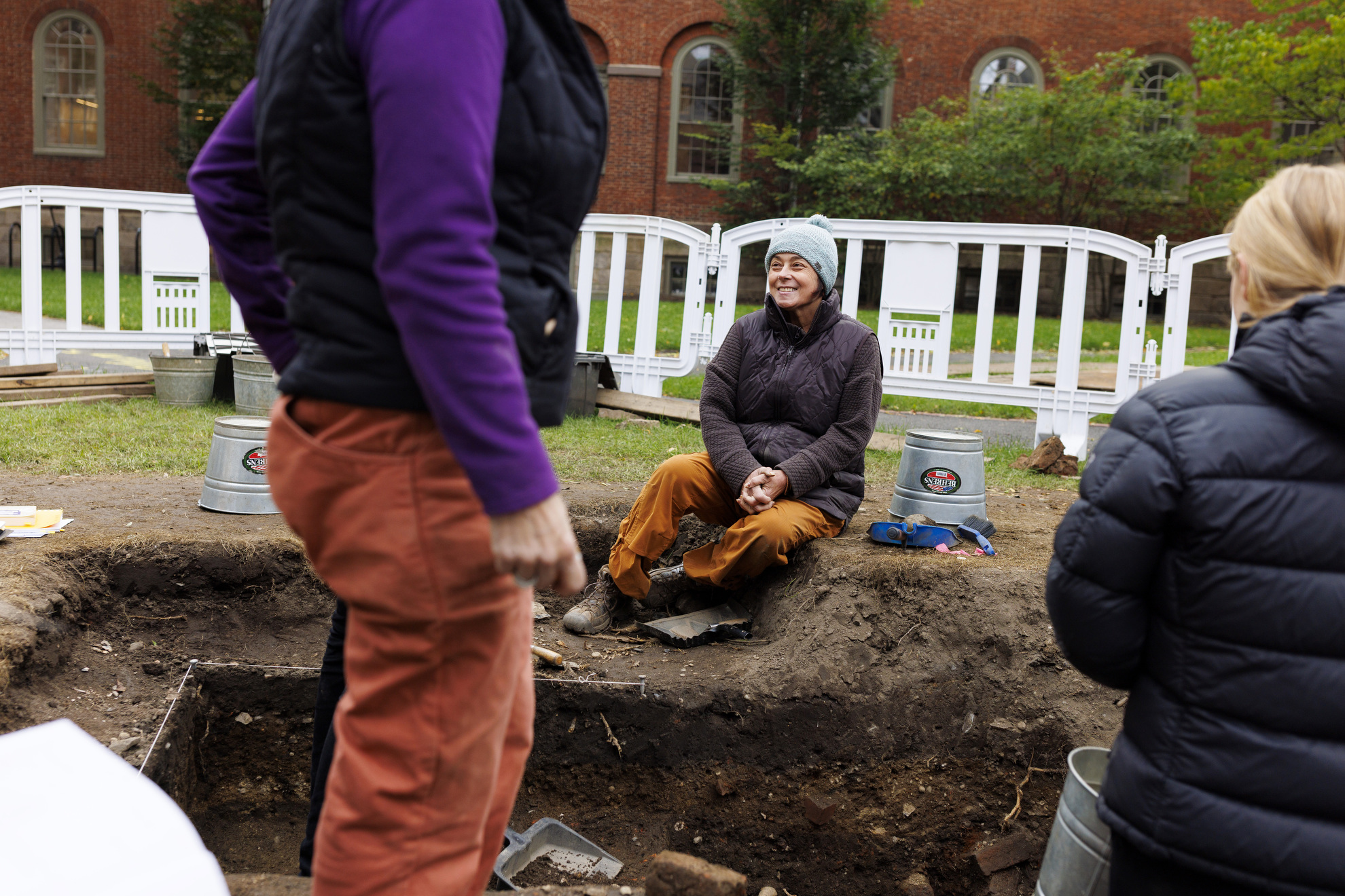Diana Loren, the deputy director for curatorial affairs and a senior curator at the Peabody Museum, sits at the edge of her team’s dig site.