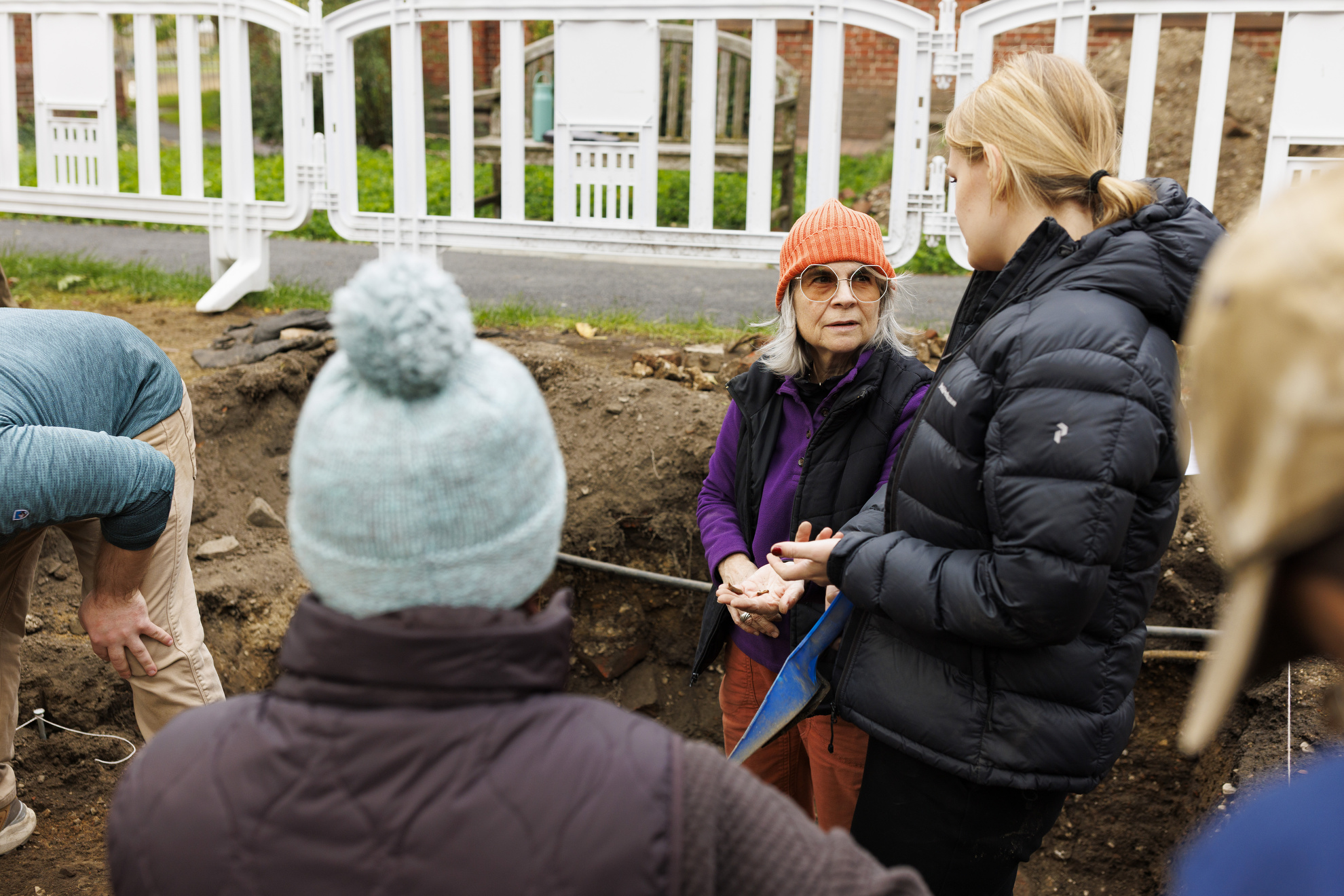 Patricia Capone (center), the Curator of North American Collections at the Peabody Museum, talks with student Nina Skov Jensen at their dig site.