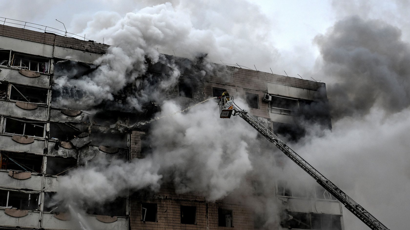A firefighter uses an aerial ladder to suppress a fire in an apartment block hit by a Russian guided aerial bomb in Zaporizhzhia, Ukraine, on December 17, 2025.