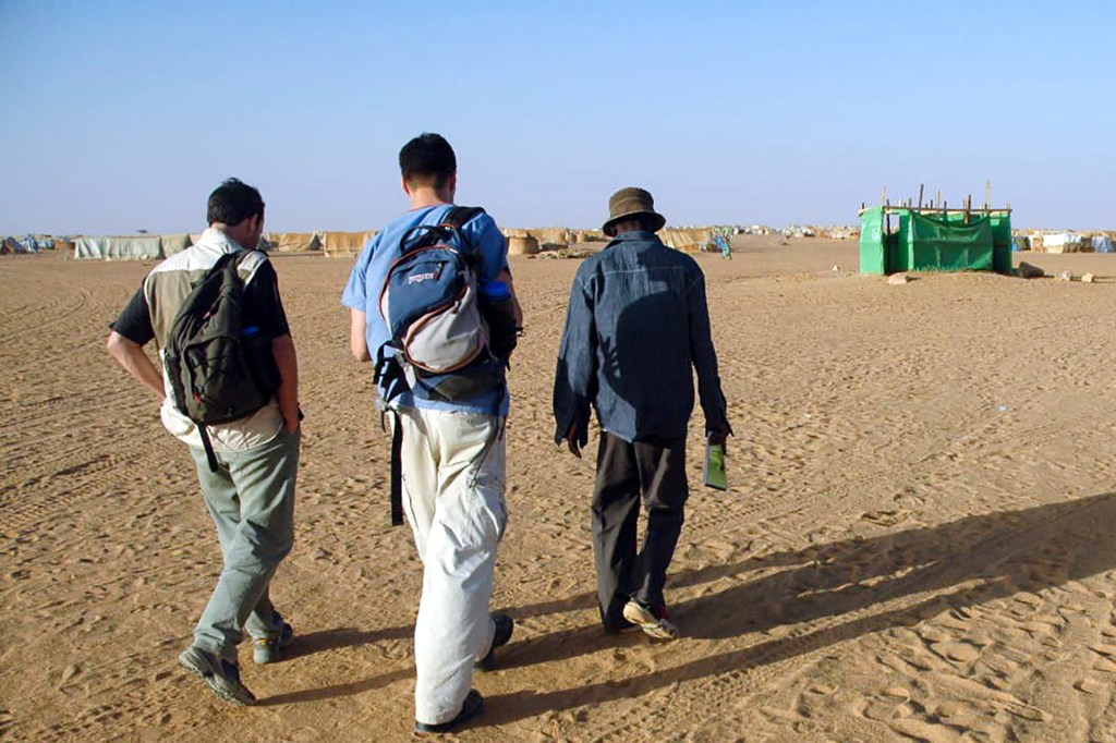 Michael VanRooyen walking with a team of humanitarian doctors in Darfur.