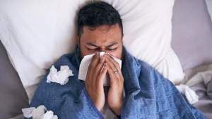 Man blowing his nose.