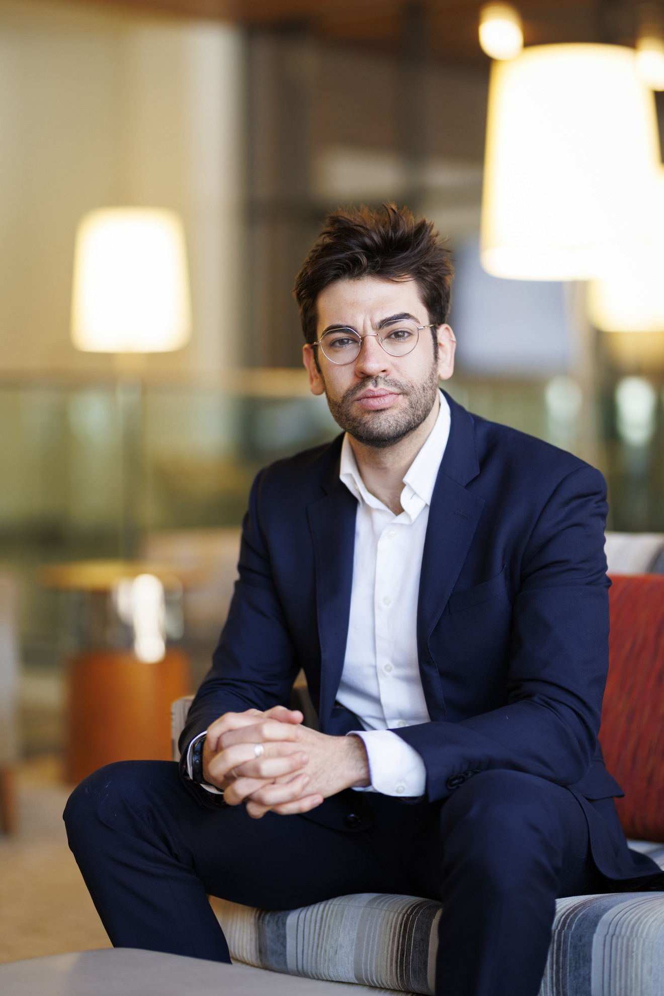 Ely Sandler seated in a chair.