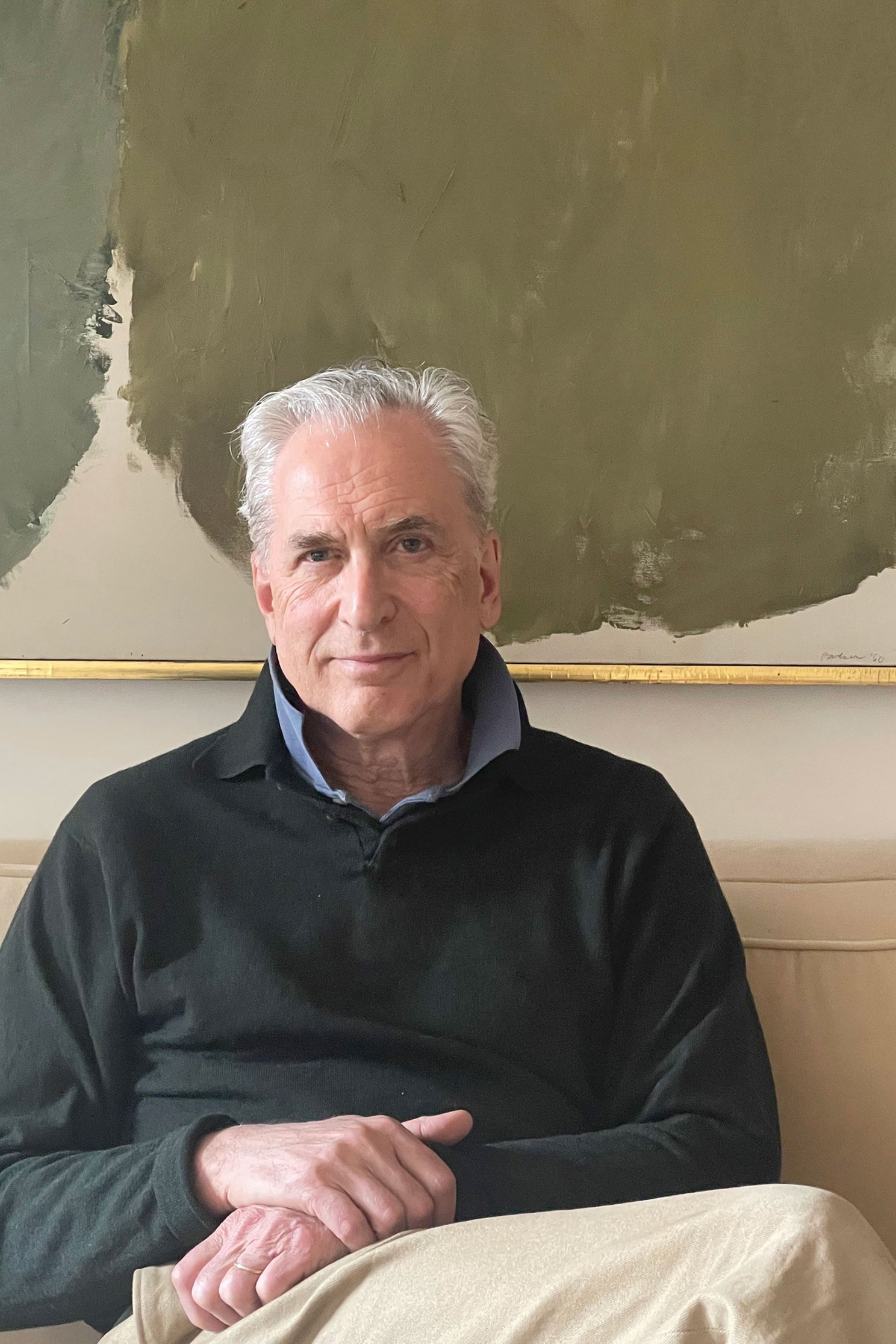 James Traub sitting for portrait with hands folded on lap.