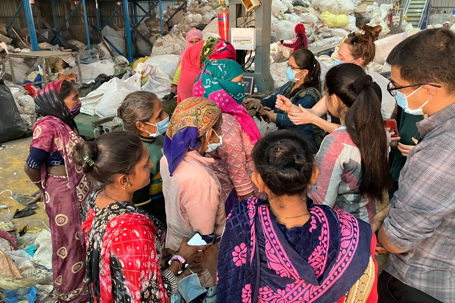 The Harvard team visits a waste recycling plant to understand the thermal comfort challenges the women face.