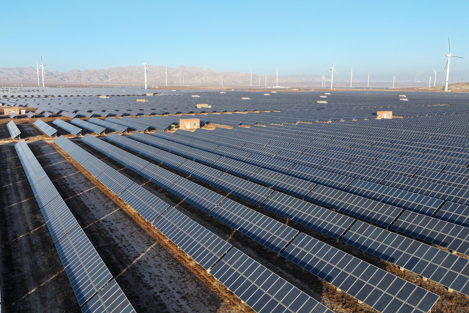 Wind turbines and photovoltaic panels are at a clean energy power plant at the foot of the Helan Mountains in Shizuishan City, Ningxia Hui Autonomous Region, China.