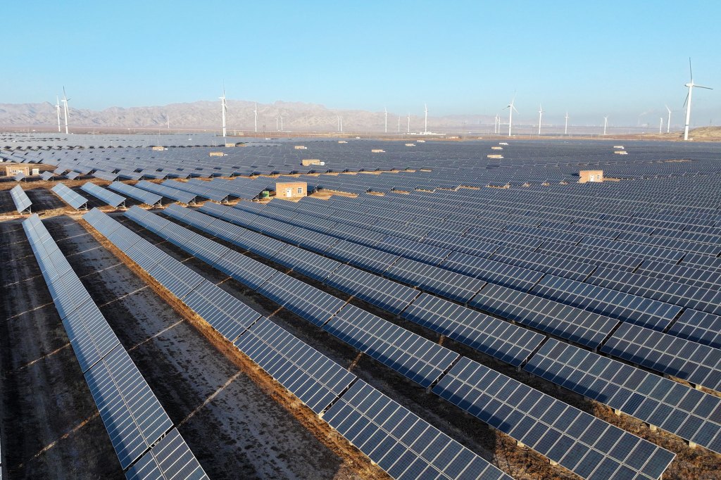Wind turbines and photovoltaic panels are at a clean energy power plant at the foot of the Helan Mountains in Shizuishan City, Ningxia Hui Autonomous Region, China.
