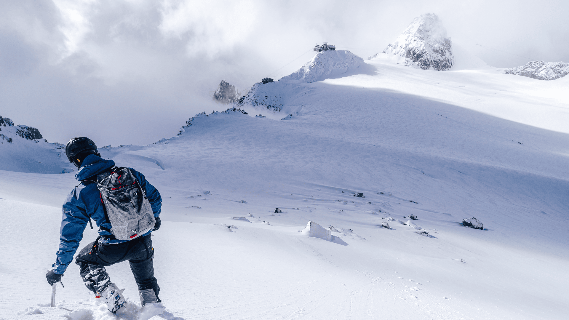 a person climbing a snowy mountain
