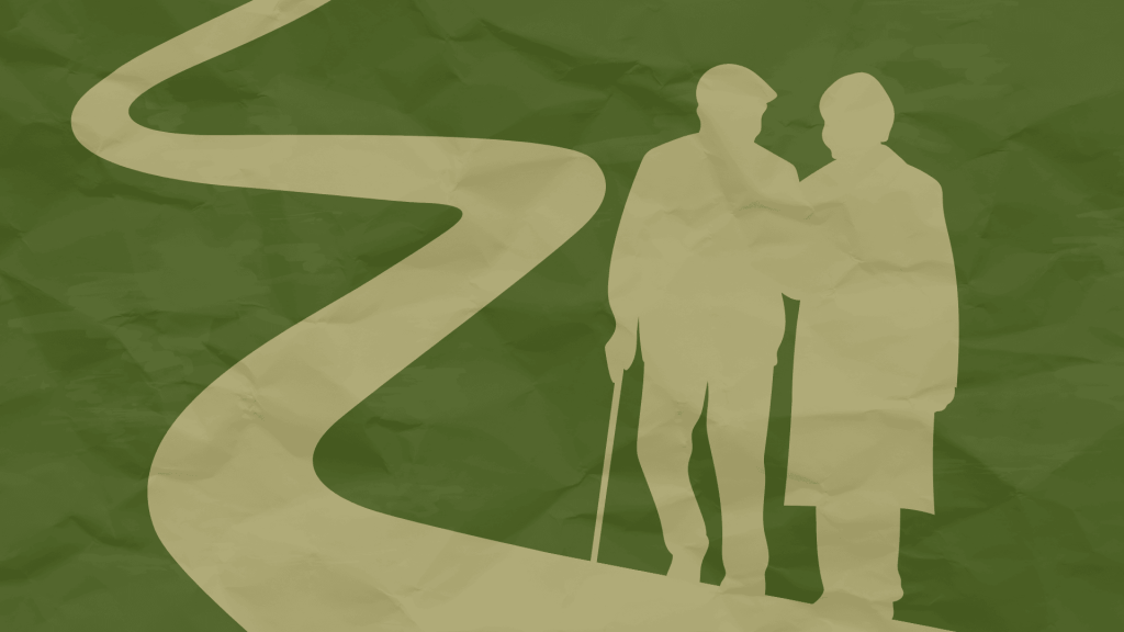 two elderly people walking on a path