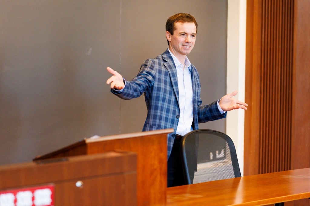 Marco Basile speaking in front of a group.